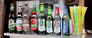 Simple row of Polish beer bottles, set, various brands, many different alcohol bottles and plastic straws. ÃÂ»ubr, LeÃÂ¼ajsk...